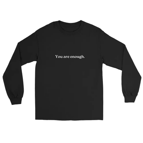 A black long-sleeve crewneck t-shirt with the phrase 'You are enough.' printed in white serif text across the chest, displayed on a solid white background.